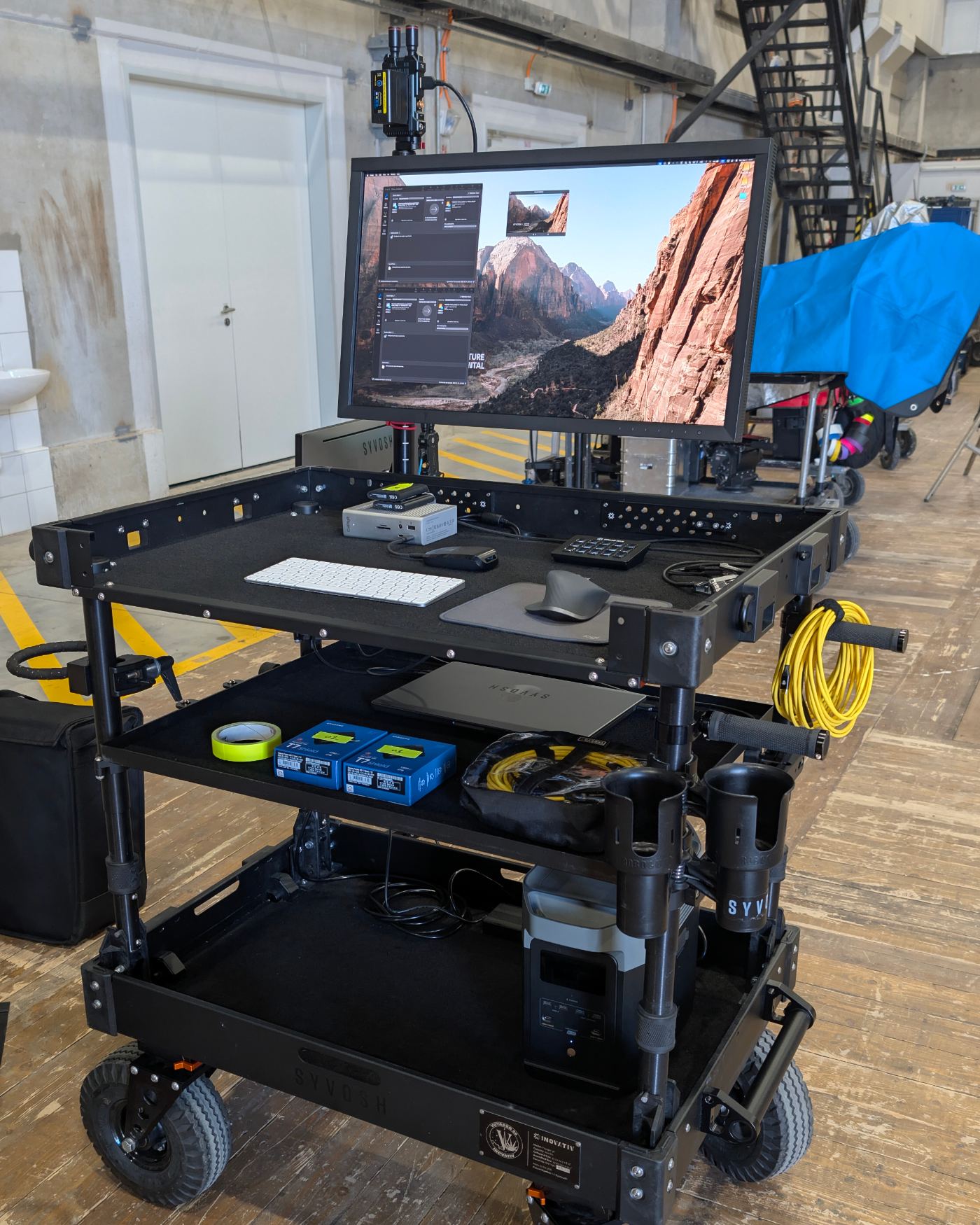 SYVOSH digital technician cart with branded capture-and-rental monitor on a colorful lit film set