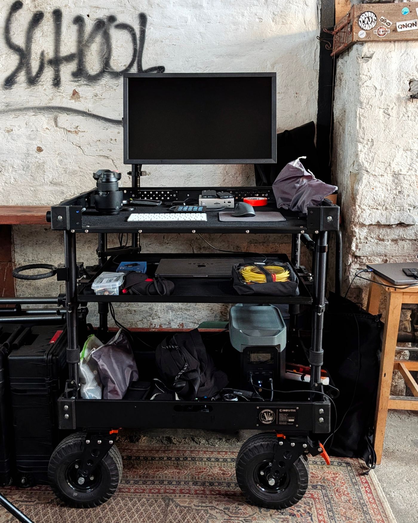 SYVOSH digital technician cart set up against a graffiti wall reading SCHOOL